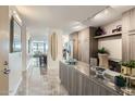 Stylish kitchen with gray cabinets, marble floors, stainless steel appliances, and lots of natural light at 4808 N 24Th St # 1003, Phoenix, AZ 85016