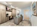 Kitchen space with gray cabinets, marble floors, stylish decor, and natural light at 4808 N 24Th St # 1003, Phoenix, AZ 85016