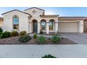 Charming home exterior features arched entryway, desert landscaping, and a well-maintained front yard at 5228 S 106Th Pl, Mesa, AZ 85212