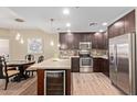 Open kitchen with stainless steel appliances, a wine fridge, and a breakfast bar, seamlessly connects to the dining area at 5450 E Deer Valley Dr # 1195, Phoenix, AZ 85054