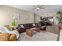 Inviting living room featuring a leather sectional sofa, stylish decor, and views into dining area and kitchen at 5450 E Deer Valley Dr # 1195, Phoenix, AZ 85054