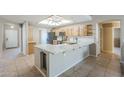 Bright, modern kitchen features light wood cabinets, white countertops, stainless steel appliances, and tile flooring at 5944 W Greenbriar Dr, Glendale, AZ 85308