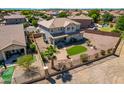 Expansive backyard featuring a well-maintained lawn, decorative rocks, privacy fence, and desert landscaping at 5973 S Legend Dr, Gilbert, AZ 85298