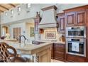 Gourmet kitchen with custom cabinets, stainless steel appliances, and a breakfast bar with counter seating at 6124 N 31St Ct, Phoenix, AZ 85016