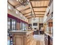 Open-concept kitchen and living area with exposed wood beams, a large island, and stainless steel appliances at 6124 N 31St Ct, Phoenix, AZ 85016