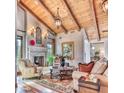 Elegant living room featuring high beamed ceilings, a stone fireplace, and stylish furnishings at 6124 N 31St Ct, Phoenix, AZ 85016