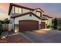 Lovely two-story home with a three-car garage and a spacious driveway for ample parking at 6449 S Glory Ct, Gilbert, AZ 85298