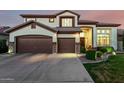 Charming two-story home boasts a three-car garage and meticulous landscaping, enhancing curb appeal at 6449 S Glory Ct, Gilbert, AZ 85298