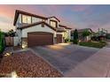 Lovely two-story home with a three-car garage and a spacious driveway for ample parking at 6449 S Glory Ct, Gilbert, AZ 85298