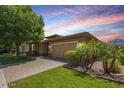 Charming single-story home with lush landscaping, inviting curb appeal, and a two-car garage at 7251 E Portobello Ave, Mesa, AZ 85212
