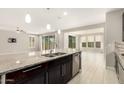 Open kitchen boasts granite counters, stainless appliances, island with sink, and a view to the living room at 7251 E Portobello Ave, Mesa, AZ 85212
