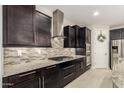 Gourmet kitchen with gas cooktop, granite counters, stainless steel appliances, and ample cabinet space at 7251 E Portobello Ave, Mesa, AZ 85212