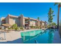 Exterior view of condos overlooking the community pool and seating areas with beautiful desert landscaping at 7436 E Chaparral Rd # B246, Scottsdale, AZ 85250