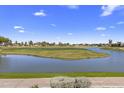 Expansive view of the lush golf course, pond, and distant residential area at 7512 N Via Camello Del Sur --, Scottsdale, AZ 85258