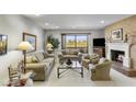 Inviting living room with cozy fireplace and view of the golf course at 7512 N Via Camello Del Sur --, Scottsdale, AZ 85258