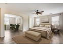 Spacious bedroom featuring a ceiling fan, ensuite sitting room, and lots of natural light from two windows at 9165 W Mine Trl, Peoria, AZ 85383
