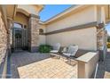 Charming front porch featuring brickwork, stone columns, and seating at 11013 E Decatur St, Mesa, AZ 85207