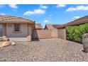 Gated side yard features desert landscaping, block wall, and access to the home at 11040 E Nichols Ave, Mesa, AZ 85209