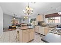 Bright kitchen with an island, light wood cabinets, stainless steel appliances, and tile flooring at 17424 N 1St Ave, Phoenix, AZ 85023