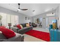 Cozy living room with vaulted ceilings, a ceiling fan, neutral paint, and a large red rug at 17424 N 1St Ave, Phoenix, AZ 85023