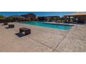 Community pool area featuring a pool, seating, and covered lounge areas at 18219 W Daley Ln, Surprise, AZ 85387