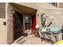 Exterior entryway featuring a security door with two bicycles and a small storage bin at 2040 S Longmore -- # 9, Mesa, AZ 85202