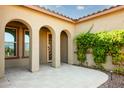Welcoming entrance with arched entryways and vibrant green vines at 21093 N Willow Rd, Maricopa, AZ 85138