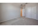 Bedroom featuring plush carpeting, neutral walls, and ample closet space at 22035 N Rummler Ln, Maricopa, AZ 85138