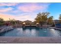 Tranquil pool with elegant water features and desert views at 24042 N 170Th Ln, Surprise, AZ 85387