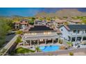 Backyard oasis with pool, covered patio, outdoor kitchen, and mountain views at 2425 W Woburn Ln, Phoenix, AZ 85085