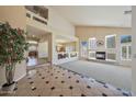 Open-concept living space with fireplace, tall ceilings, and natural light at 2425 W Woburn Ln, Phoenix, AZ 85085