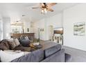 Cozy living room featuring neutral tones, comfortable seating, and a decorative ceiling fan at 2768 W Jasper Butte Dr, San Tan Valley, AZ 85144
