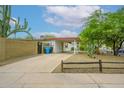 Exterior of home with covered parking, brick perimeter wall, and desert landscaping at 2901 W Mandalay Ln, Phoenix, AZ 85053