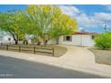 Charming home featuring desert landscaping, a vibrant tree, and a circular driveway at 2901 W Mandalay Ln, Phoenix, AZ 85053