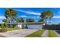 Beautiful single-story home featuring a lush lawn, desert landscaping, and a private gated entrance at 3027 W Wescott Dr, Phoenix, AZ 85027