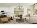 Comfortable living room features stylish furniture, modern lighting, and seamless flow to the kitchen area at 3238 E Outlaw Ln, San Tan Valley, AZ 85140