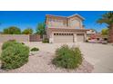 This home features a 3-car garage, low-maintenance landscaping, and an enclosed gate for enhanced privacy at 346 W Oxford Ln, Gilbert, AZ 85233