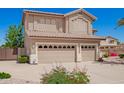 This home showcases a three-car garage with updated doors, neutral paint and a low-maintenance yard at 346 W Oxford Ln, Gilbert, AZ 85233
