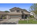 Charming home showcasing a well-kept lawn, neutral stucco facade, and convenient attached two-car garage at 3478 E Park Ave, Gilbert, AZ 85234