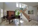 Bright foyer featuring wood-look tile floors, tall ceilings, and a staircase at 3649 E Hutchins Ct, Gilbert, AZ 85295