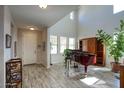 Bright entryway with wood-look tile, tall ceilings and a grand piano at 3649 E Hutchins Ct, Gilbert, AZ 85295