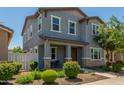 Attractive two-story home boasting a covered porch and manicured front garden at 3850 E Robert St, Gilbert, AZ 85295