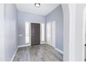 Inviting foyer with wood-look tile flooring, coat closet and natural light from sidelight windows at 4214 E Morrow Dr, Phoenix, AZ 85050