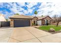 Attractive single-story home featuring a two-car garage, well-kept lawn, and desert landscaping at 4214 E Morrow Dr, Phoenix, AZ 85050