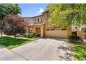 Inviting home exterior boasting a spacious driveway, mature trees, and attractive stone detailing at 4355 E Cullumber St, Gilbert, AZ 85234