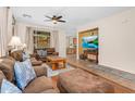 Spacious living area featuring a ceiling fan, large windows, and an open layout at 4355 E Cullumber St, Gilbert, AZ 85234