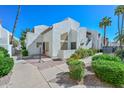 Condo's attractive exterior with a red bistro set and nice landscaping at 4730 W Northern Ave # 1141, Glendale, AZ 85301