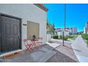 Condo's exterior with a red bistro set and covered porch at 4730 W Northern Ave # 1141, Glendale, AZ 85301