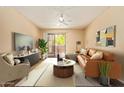 Staged living room with contemporary furnishings and natural light from sliding glass door at 5757 W Eugie Ave # 2084, Glendale, AZ 85304