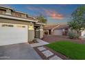 Close up of a charming two-story home featuring a well-maintained lawn and spacious three-car garage at 5919 S Banning St, Gilbert, AZ 85298